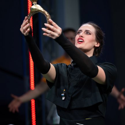 Sängerin hält Pokal in die Höhe