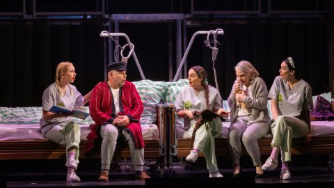 Pflegerinnen lesen Hans und Grete aus einem Buch vor